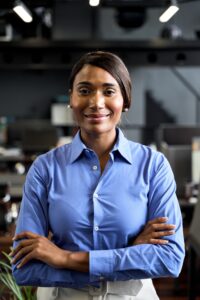 Confident young African American business woman leader in office, portrait.